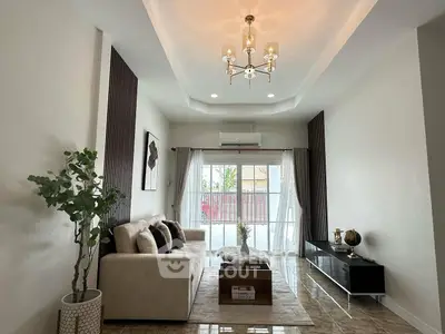 Elegant living room with modern chandelier and cozy seating area
