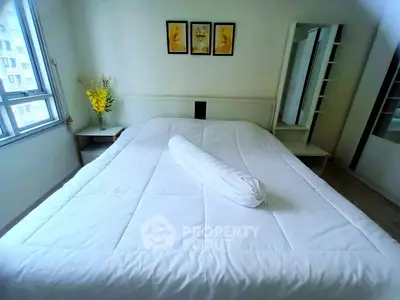 Spacious bedroom with large bed and modern decor in a bright apartment.