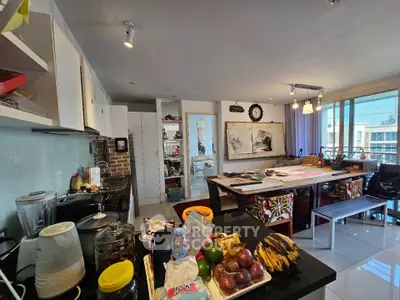 Spacious open-layout kitchen and dining area with modern decor and ample natural light.