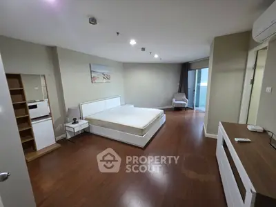 Spacious bedroom with modern furnishings and balcony access