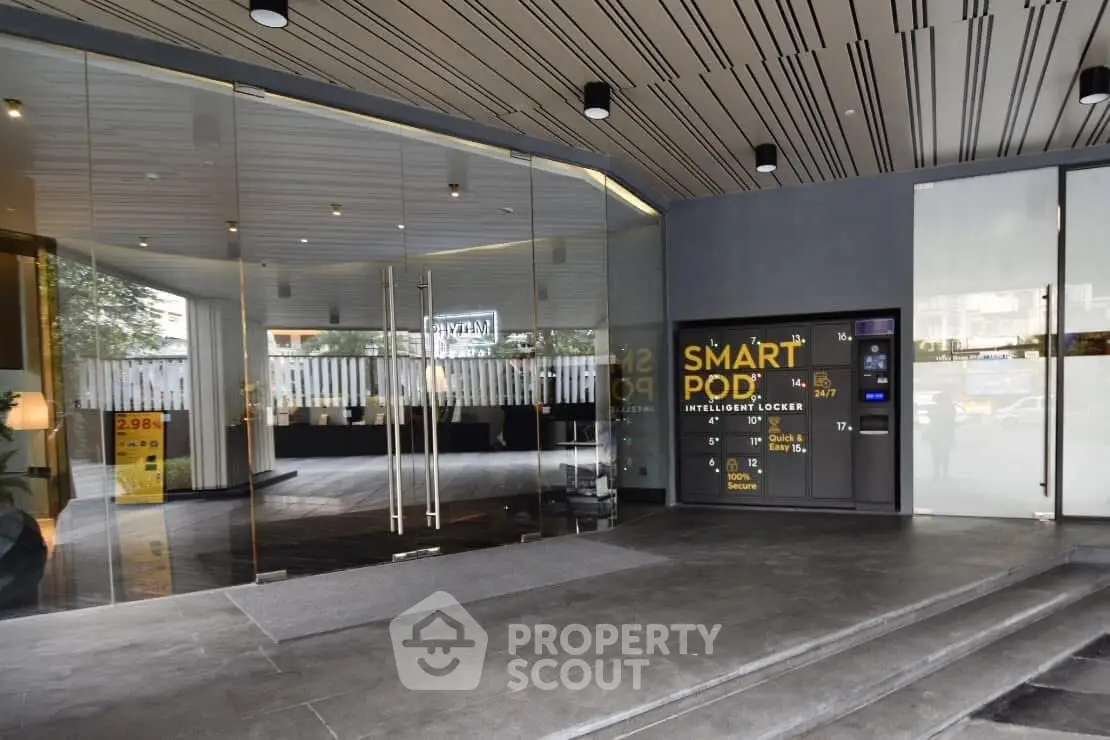 Modern building entrance with smart locker and sleek glass doors