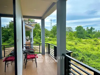 Spacious balcony with scenic green views and comfortable seating, perfect for relaxation and outdoor enjoyment.