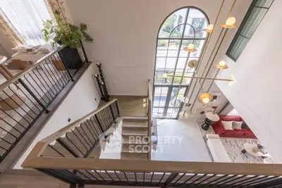 Stunning modern living room with high ceilings and large windows offering abundant natural light.