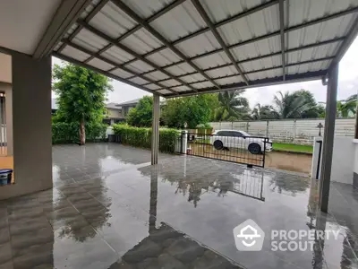 Spacious covered patio with sleek tiled flooring and lush garden view