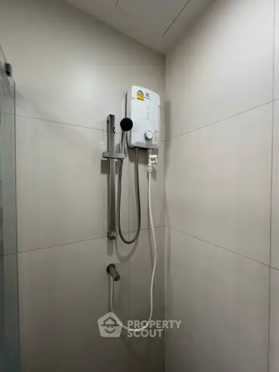 Modern bathroom with sleek shower unit and neutral tiles