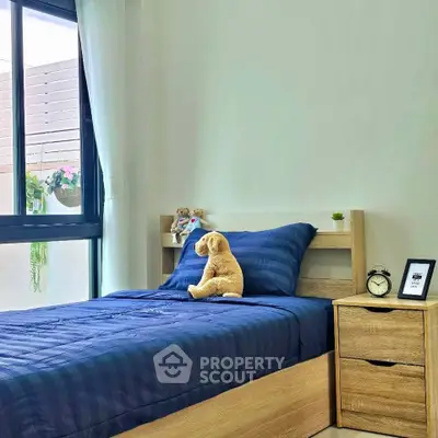 Cozy bedroom with plush bedding and natural light, perfect for relaxation.