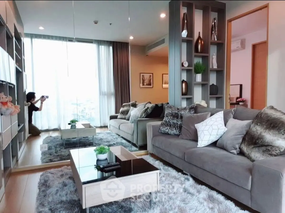 Luxurious modern living room with plush sofas and stylish decor, perfect for relaxation and entertainment.