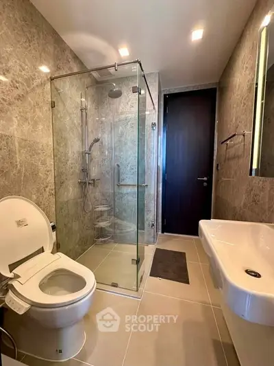 Luxurious modern bathroom with glass shower and elegant fixtures