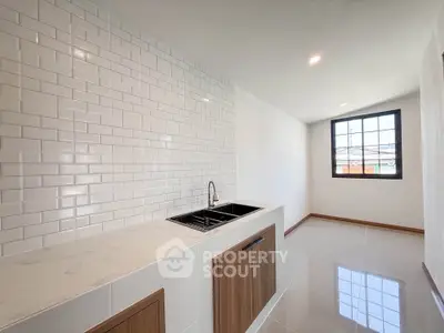 Modern kitchen with sleek white subway tiles and elegant wooden cabinetry