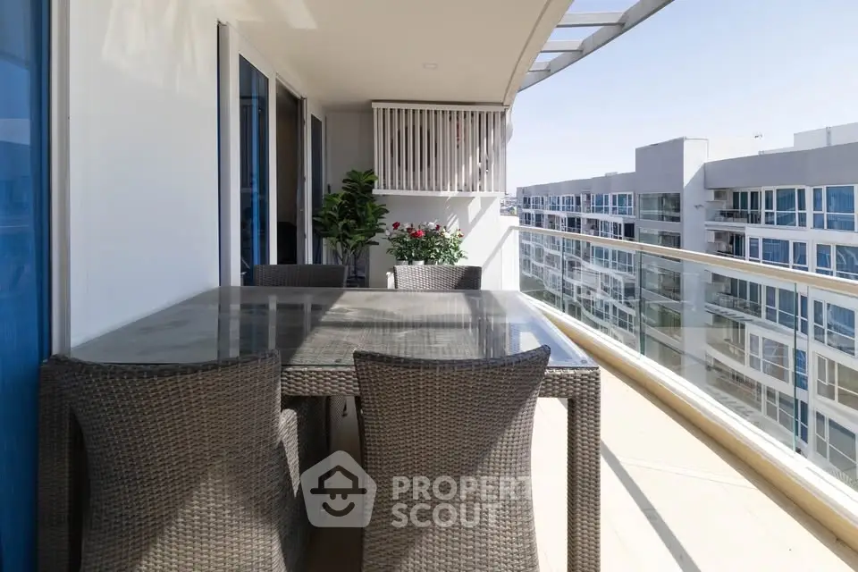 Spacious balcony with modern furniture and city view in luxury apartment