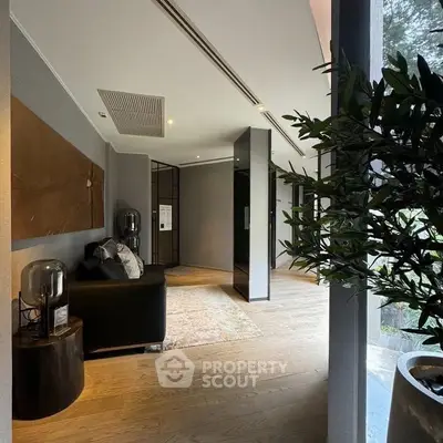 Modern living room with stylish decor and large windows offering natural light.