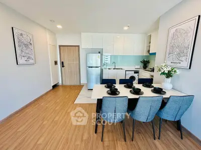 Modern kitchen with dining area featuring sleek appliances and stylish decor