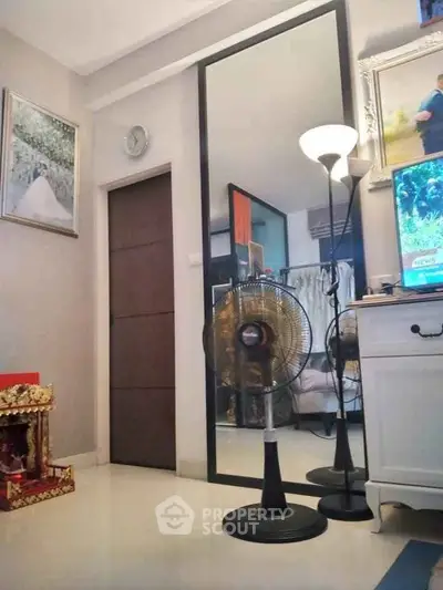 Charming bedroom with elegant decor, large mirror, and cozy lighting for a serene ambiance.