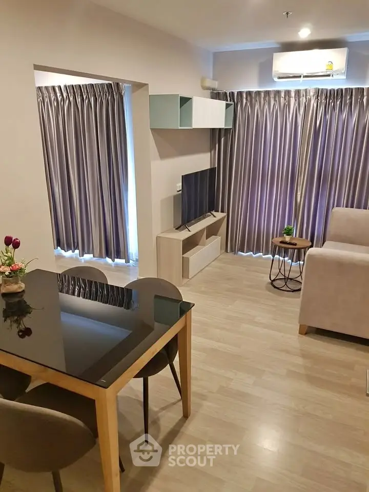 Modern living room with sleek furniture and natural light, perfect for cozy gatherings.