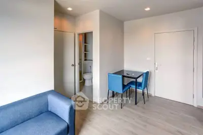 Modern apartment interior with cozy blue sofa and dining area