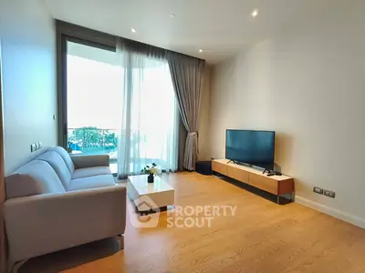 Spacious modern living room with large window and stylish furniture