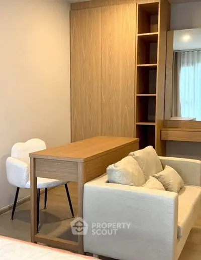 Modern living room with stylish furniture and wooden accents, perfect for cozy relaxation.