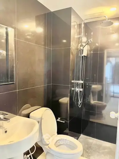 Modern bathroom with sleek black tiles and contemporary fixtures
