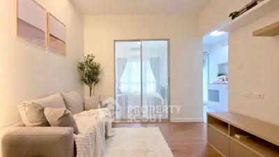 Cozy living room with modern decor and natural light, perfect for relaxation.