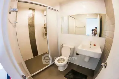 Modern bathroom with sleek shower and minimalist design in a contemporary apartment.