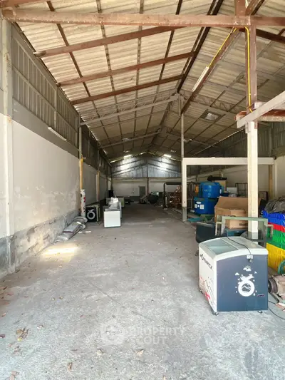 Spacious industrial warehouse with high ceilings and ample storage space.
