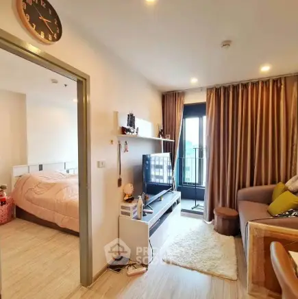 Modern living room with cozy decor and balcony access in a stylish apartment.