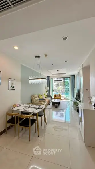 Modern living room with elegant dining area and balcony view