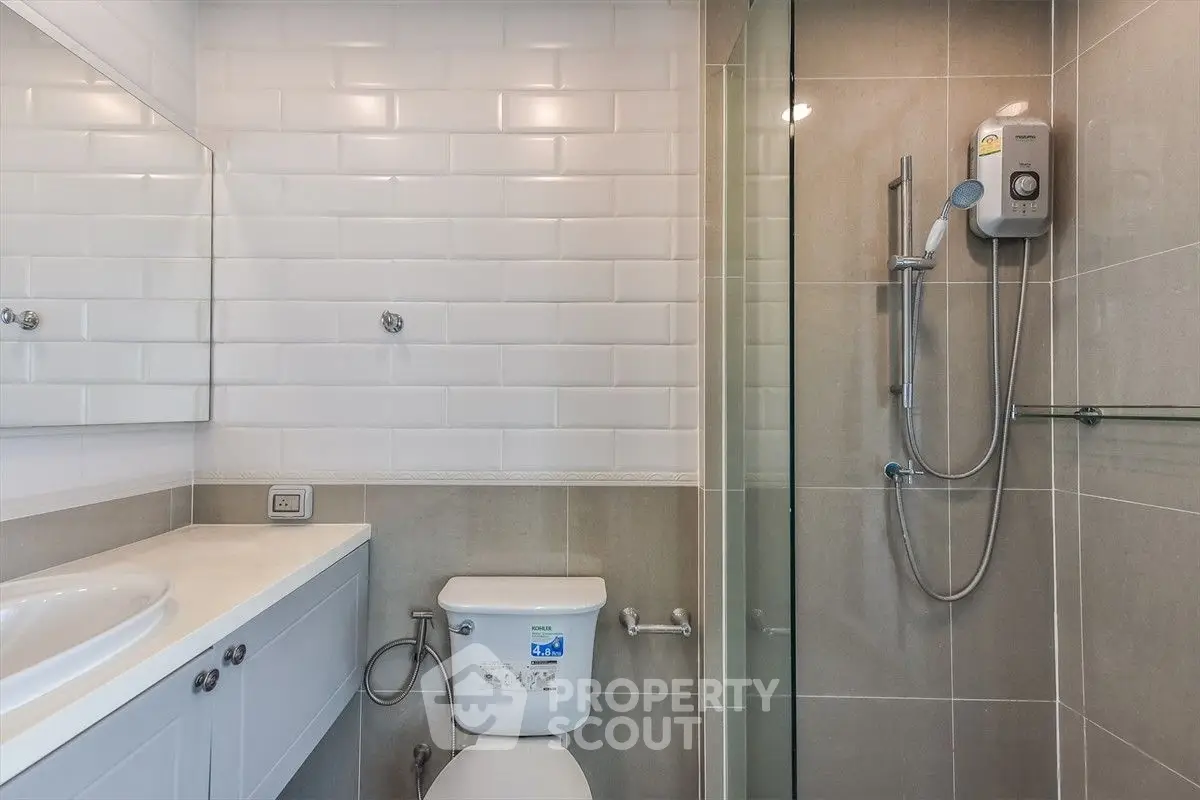 Modern bathroom with sleek shower and white subway tiles