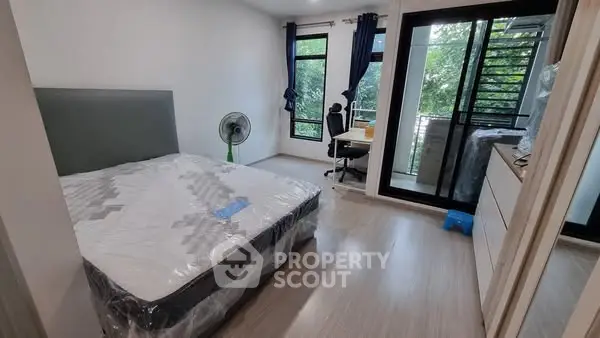 Spacious bedroom with balcony access and natural light