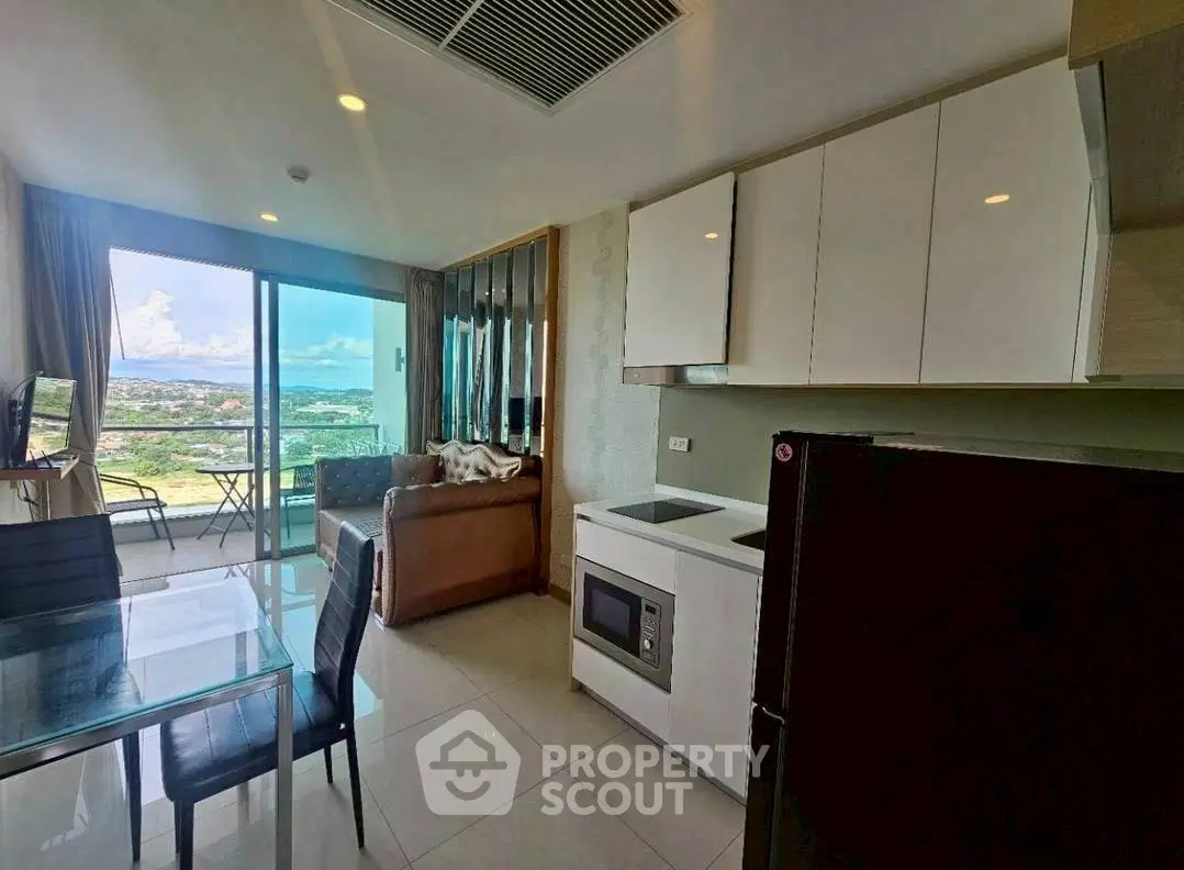 Modern condo with stunning view, open kitchen, and cozy living area.
