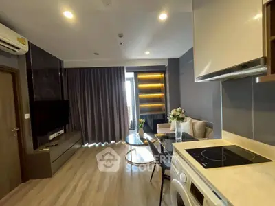 Modern living room with open kitchen, featuring sleek design and natural light.