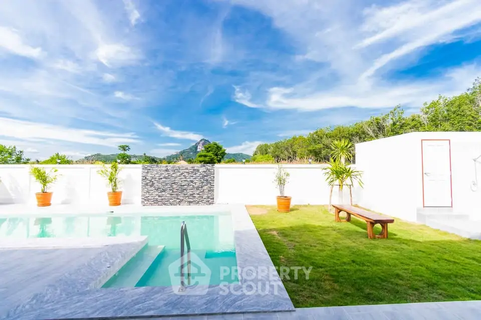 Stunning poolside view with lush greenery and mountain backdrop