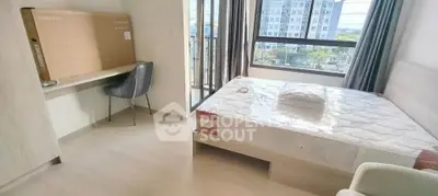 Modern bedroom with large window and new mattress in a bright apartment