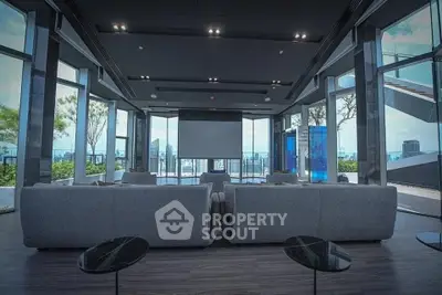Luxurious modern living room with panoramic city views and sleek furniture.