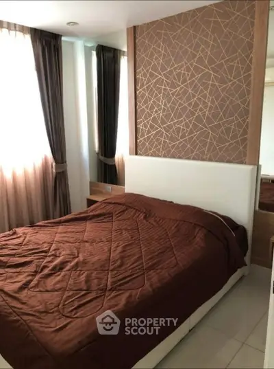 Modern bedroom with stylish decor and natural light, featuring elegant curtains and a cozy bed.
