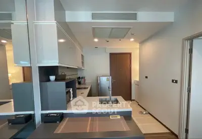 Modern kitchen with sleek cabinetry and integrated appliances in a stylish apartment.