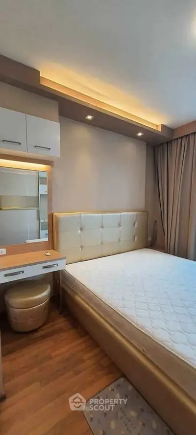 Modern bedroom with stylish lighting and elegant furnishings in a cozy apartment.