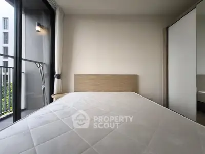 Modern bedroom with balcony access in urban apartment