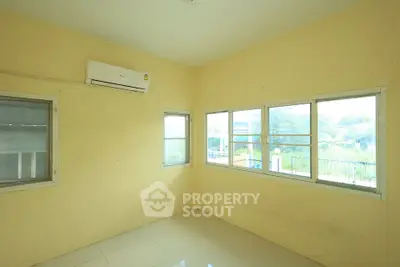 Bright room with large windows and air conditioning, perfect for a cozy living space.
