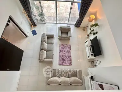 Spacious modern living room with large windows and elegant furniture, perfect for relaxation and entertainment.