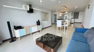 Spacious modern living room with sleek furniture and open dining area