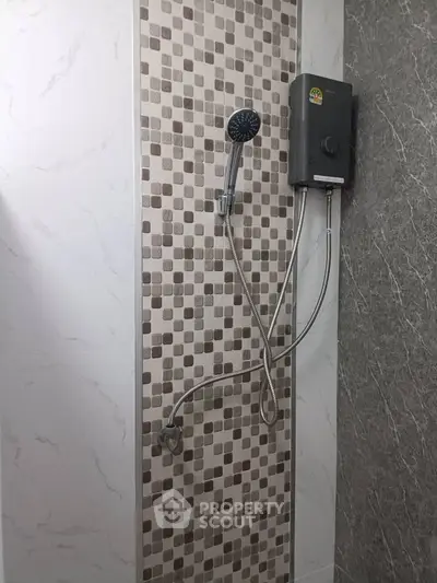 Modern bathroom shower with stylish tile design and water heater installation.