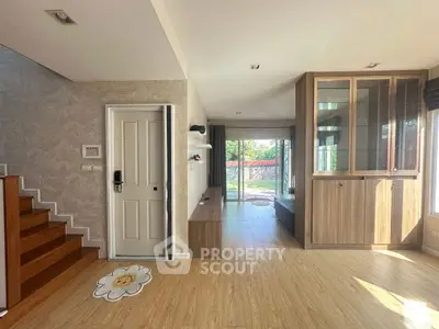 Spacious modern living area with wooden flooring and large windows