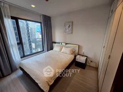 Modern bedroom with city view, featuring sleek design and ample natural light.