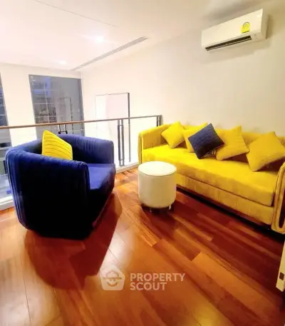 Stylish modern living room with vibrant furniture and wooden flooring