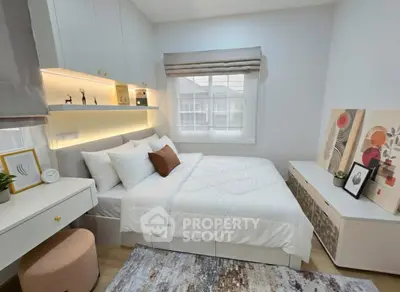 Cozy modern bedroom with stylish decor and ample natural light