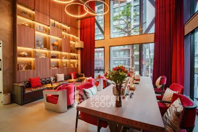 Luxurious modern living room with high ceilings, elegant decor, and large windows offering city views.