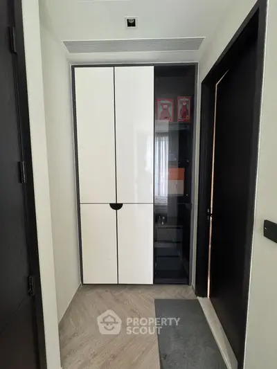 Modern storage area with sleek cabinetry and elegant flooring