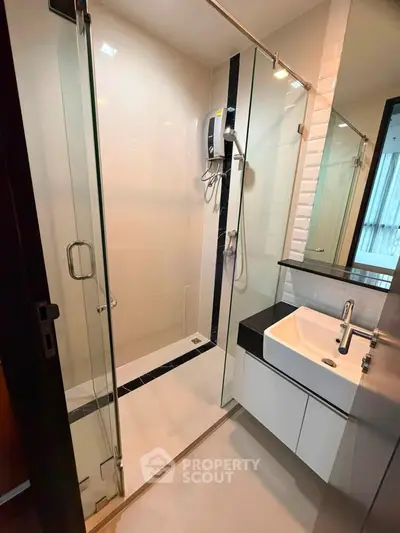 Modern bathroom with glass shower and sleek sink design
