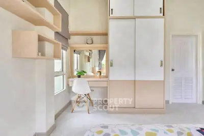 Modern bedroom with built-in wardrobe and stylish desk area